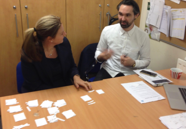 interaction designer Matt researching which content is most valuable to one of our colleagues with a paper prototype.